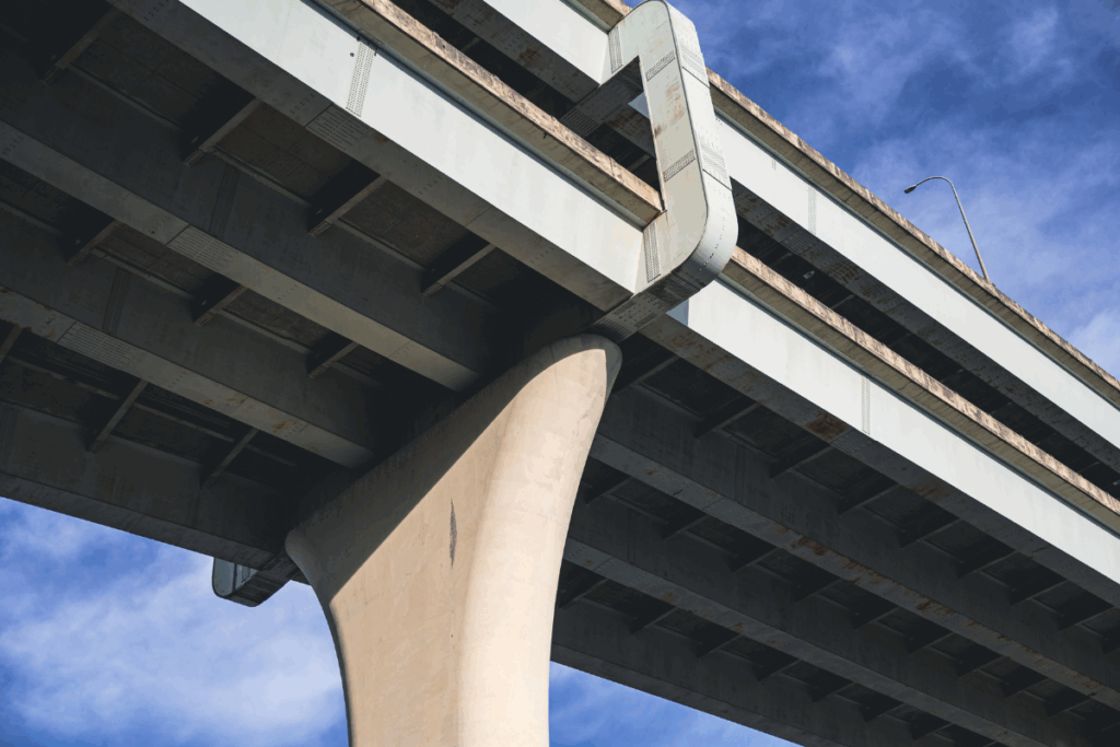 Close-up of a bridge abutment with the sky and clouds behind it