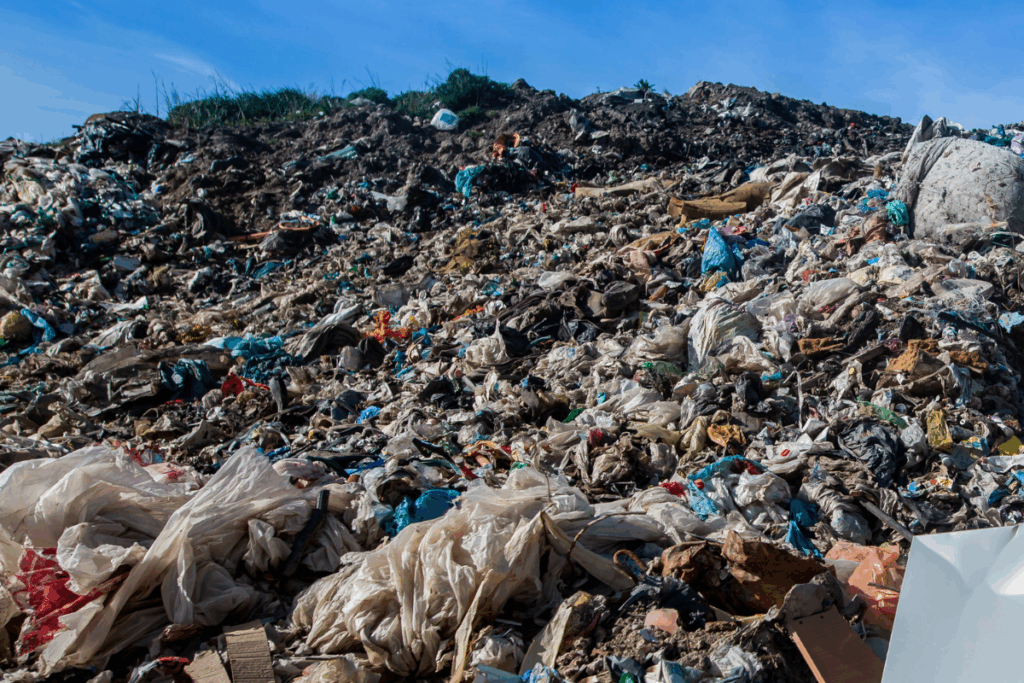 Tonnes of combustible waste piled up with a blue sky and clounds