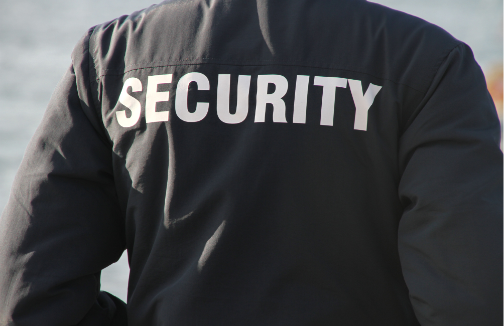 Close up of security guards back with the word 'security' as the main focus on the jacket