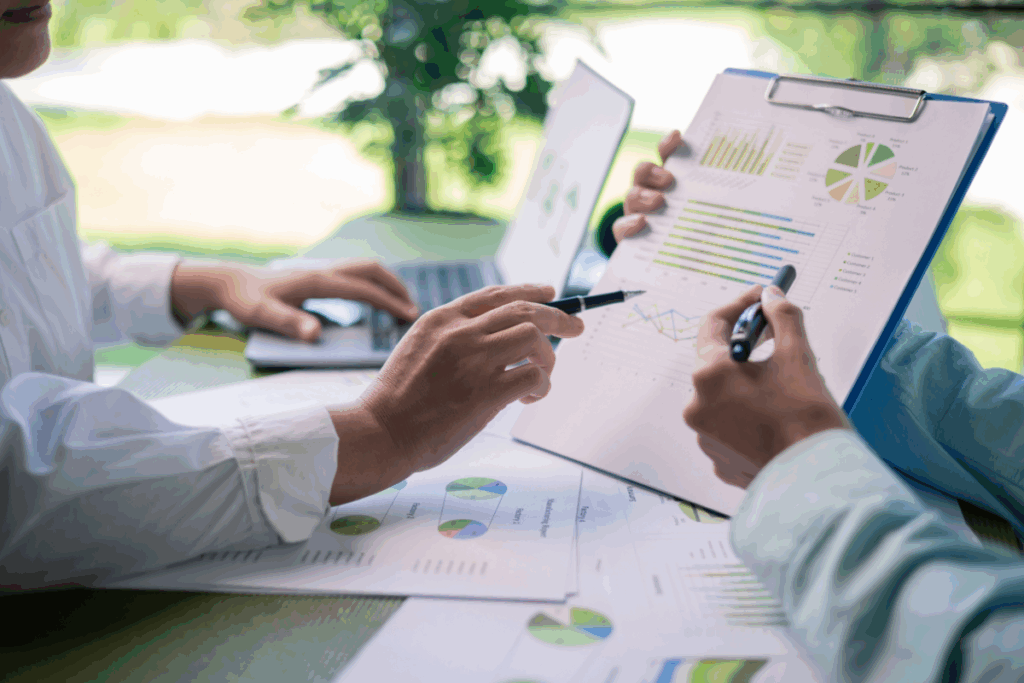 Business owners reviewing sustainability reporting documents for compliance