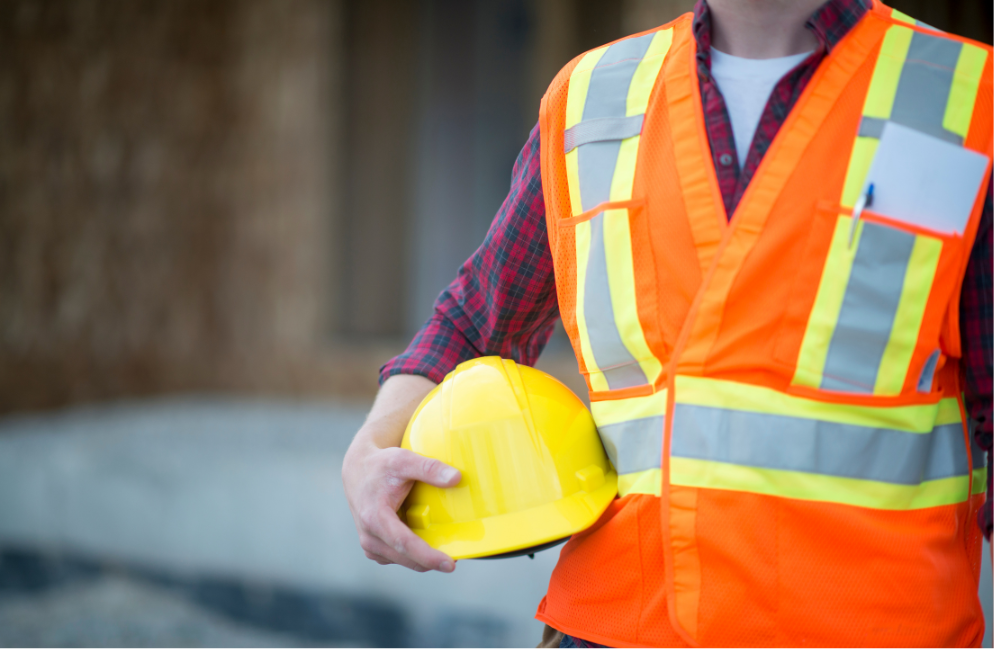 Man in health and safety uniform with hard hat close up