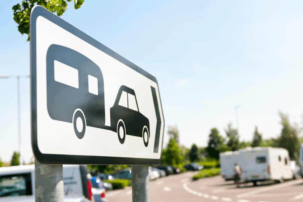 Caravan park road sign with caravans and trees blurred in the background