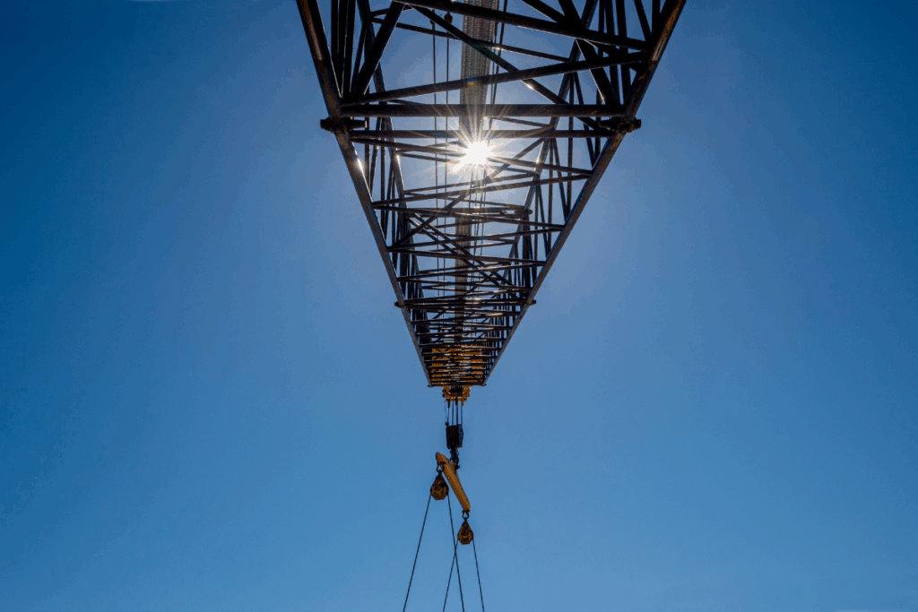 Blue sky and sun view of a crane, lifting device