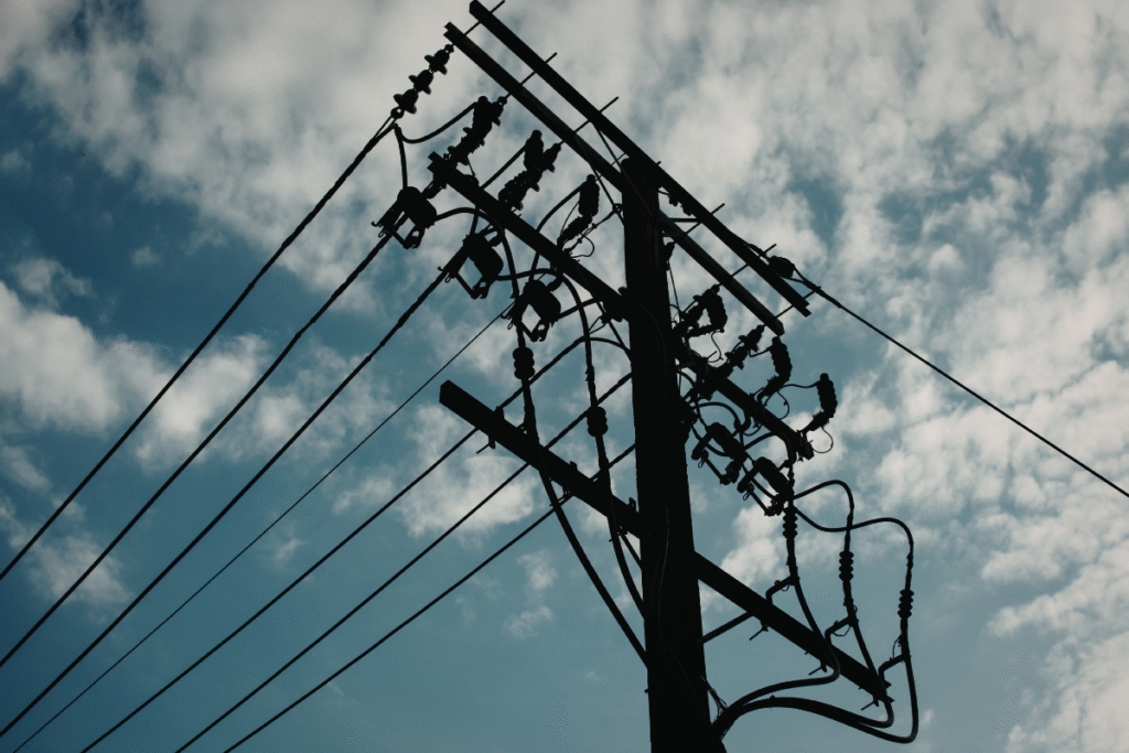 Overhead cable lines with sky and clouds