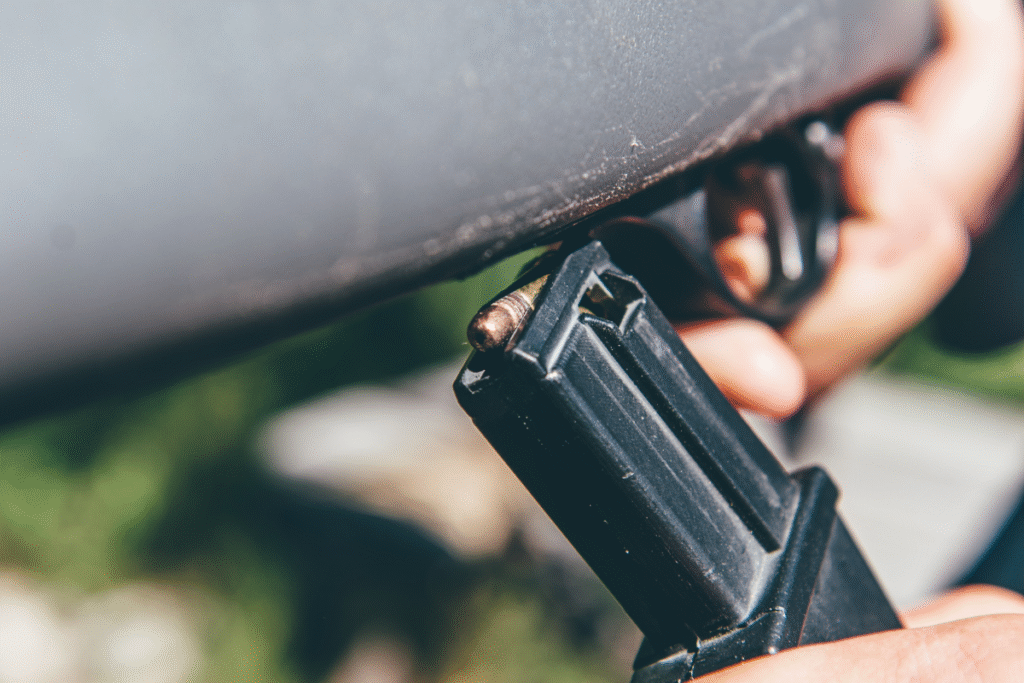 An up close shot of a person holding a black rifle