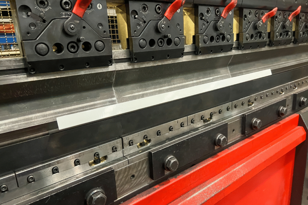 1.84‑tonne press brake in a factory with red and black and steel parts