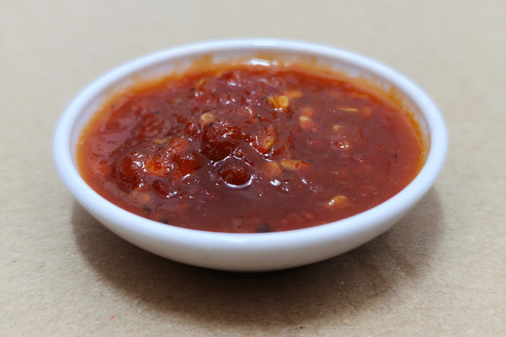 chilli sauce in a small white dipping bowl