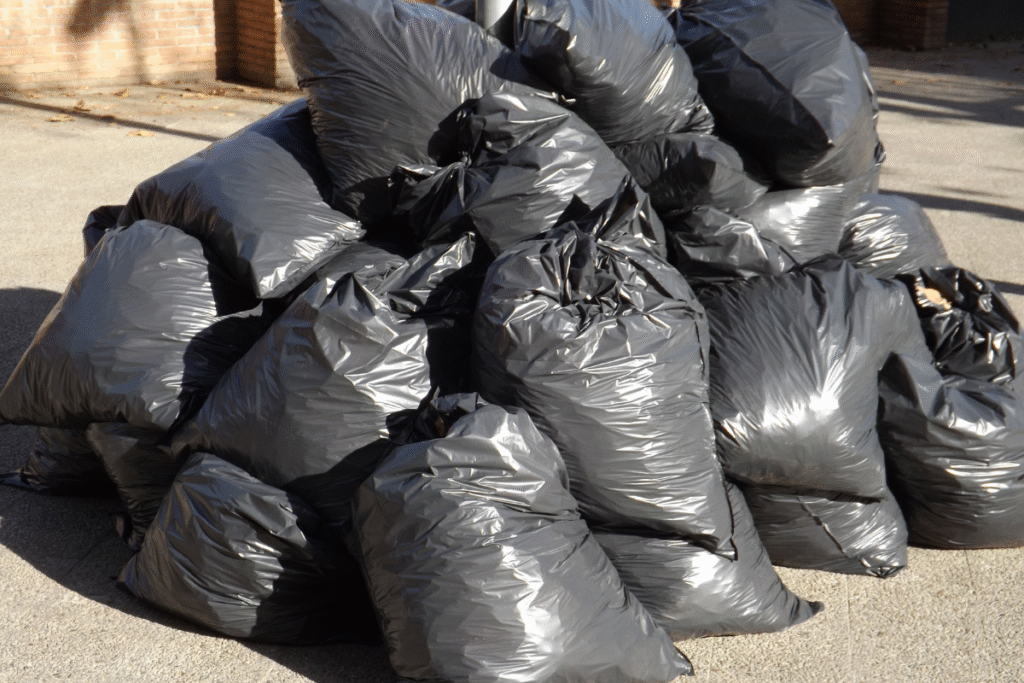 Bin bags full of waste on the street piled up on top of each other