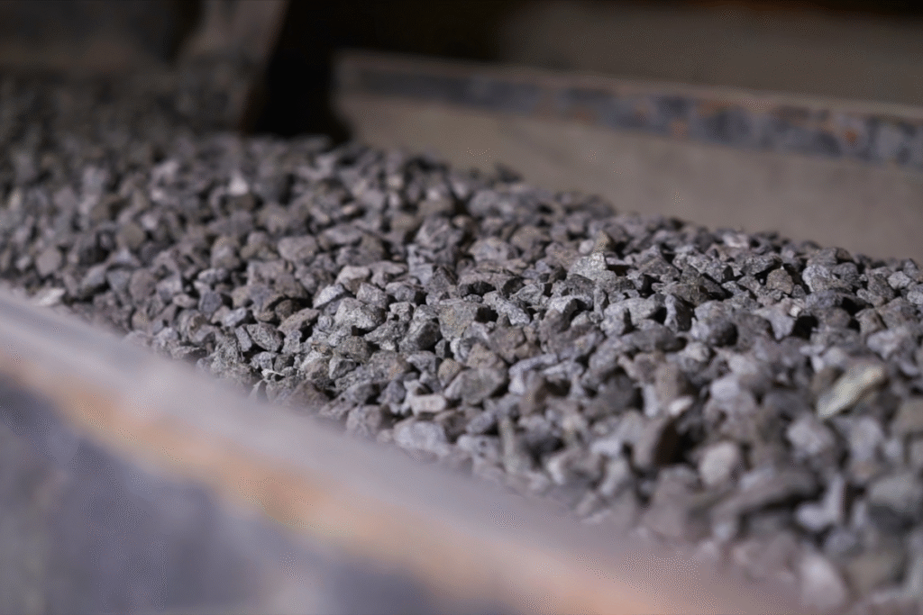 Belt of a rock crushing machine close up with grey rocks on