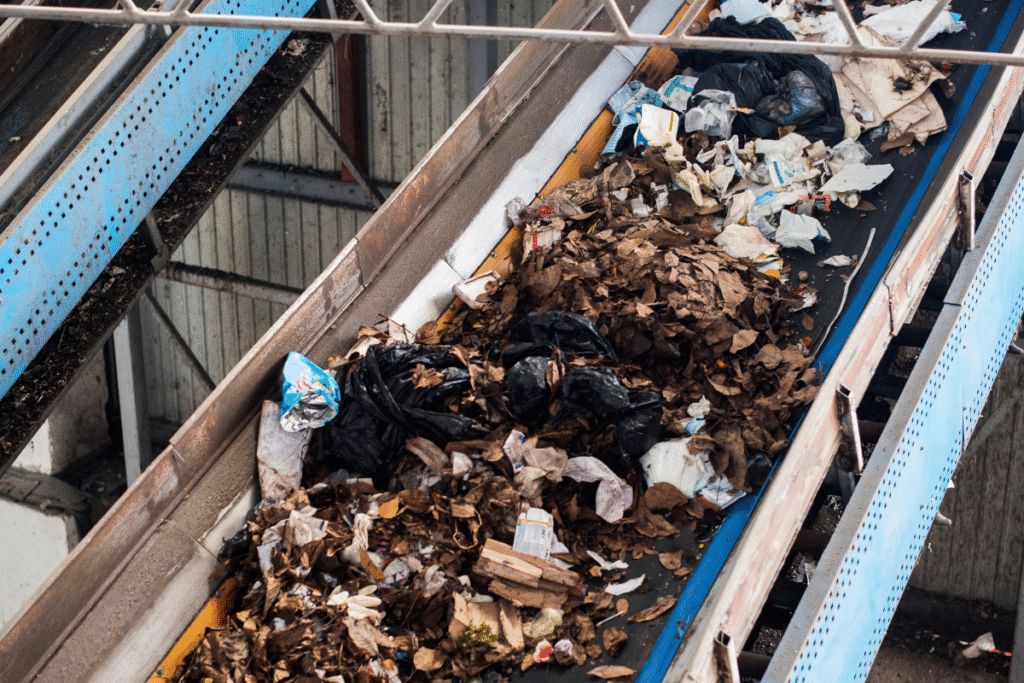 An industrial conveyor belt with recycling waste on