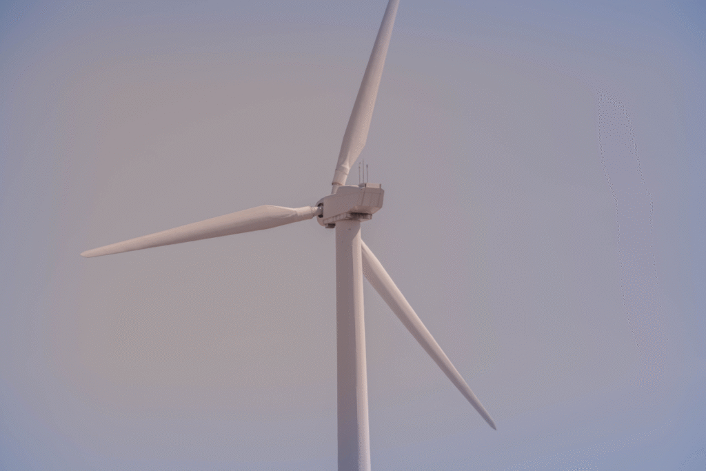 White wind turbine blade with dark skies behind it
