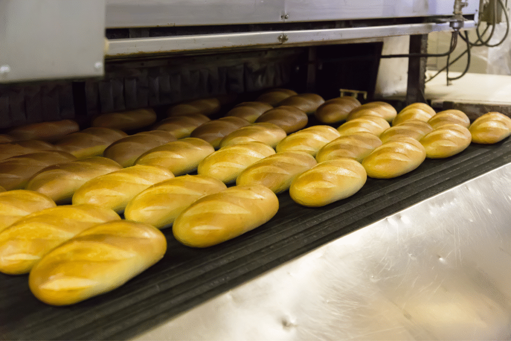Lots of baked breads on an industrial tray