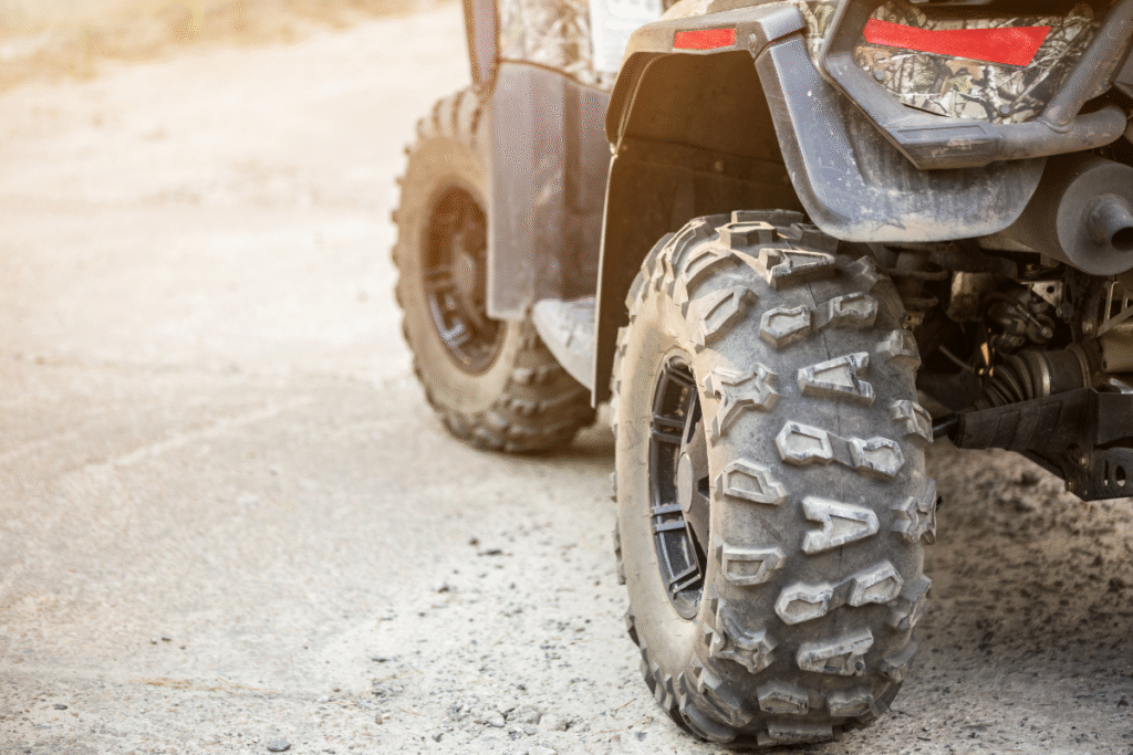 Quad bike wheels on sandy floor