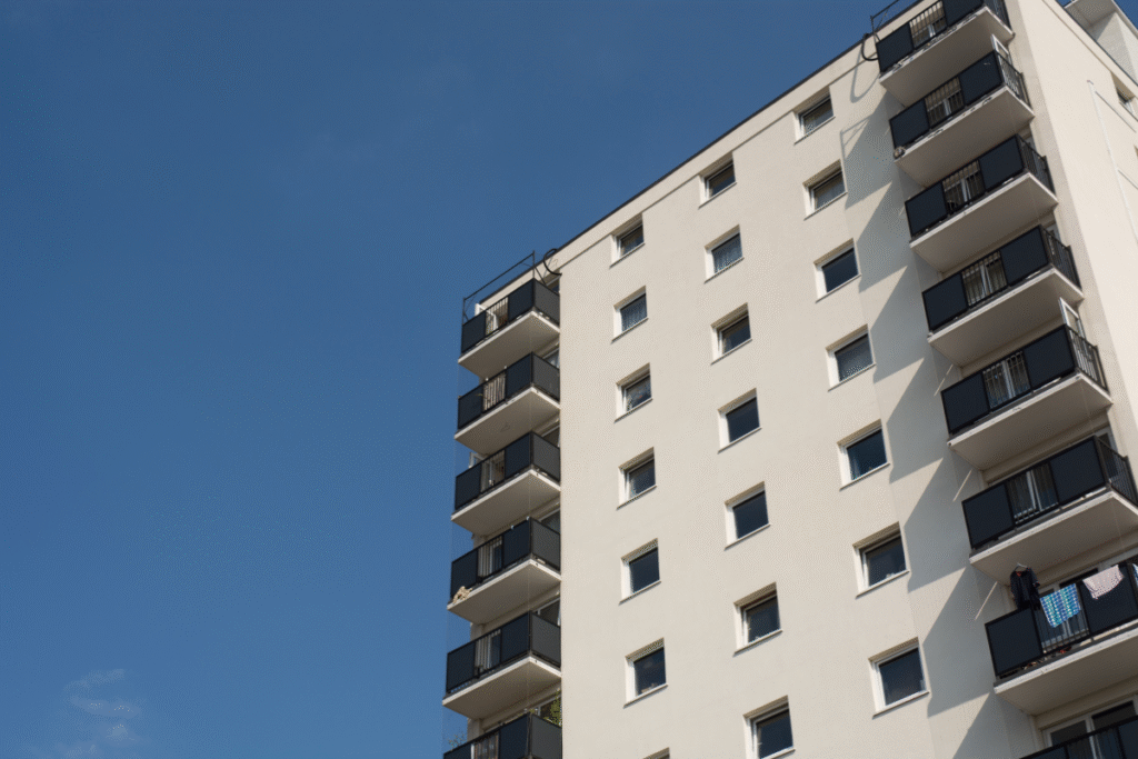 A high rise block of flats with blue sky behind it