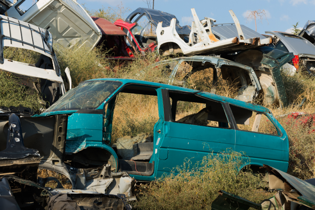of end-of-life vehicles on a site of green land